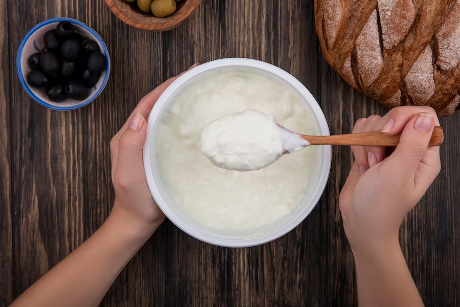 https://www.freepik.com/free-photo/top-view-woman-eating-yogurt-bowl-with-wooden-spoon-olives-black-bread-wooden-background_12350897.htm#query=greek%20yoghurt&position=1&from_view=search&track=ais