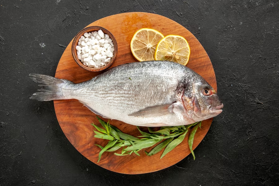https://www.freepik.com/free-photo/top-view-tarragon-raw-sea-fish-sea-salt-bowl-lemon-slices-round-wood-board-black_17235278.htm#query=fish&position=14&from_view=search&track=sph